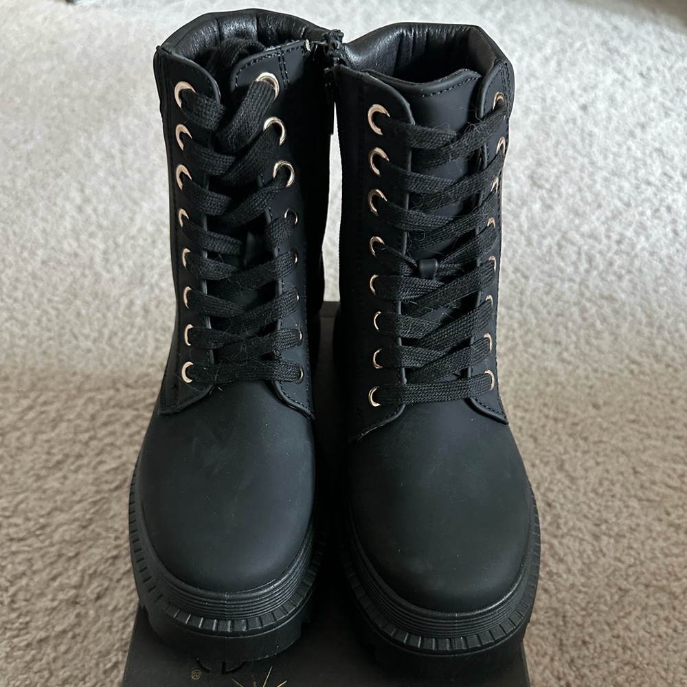 Sleek Black Combat Boots with Gold Eyelets